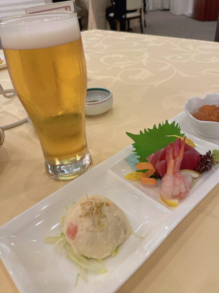 生ビールと、席に配膳された前菜の小皿